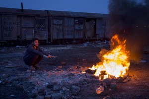 A migrant sits around a fire to warm himself from the cold outside an abandoned warehouse in Belgrade, Serbia on February 3, 2017. Hundreds of migrants have been sleeping in freezing conditions in downtown Belgrade looking for ways to cross the heavily guarded EU borders.