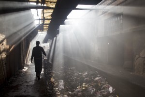 A migrant walks inside an abandoned warehouse where he and other migrants took refuge in Belgrade, Serbia on February 4, 2017. Hundreds of migrants have been sleeping in freezing conditions in central Belgrade looking for ways to cross the heavily guarded EU borders.