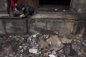 A refugee washes his face in an abandoned warehouse where he and other migrants took refuge in Belgrade, Serbia on February 5, 2017. Hundreds of migrants have been sleeping in freezing conditions in central Belgrade looking for ways to cross the heavily guarded EU borders.