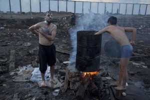 Refugees shower outside an abandoned warehouse where they took refuge in Belgrade, Serbia on February 4, 2017. Hundreds of migrants have been sleeping in freezing conditions in central Belgrade looking for ways to cross the heavily guarded EU borders.