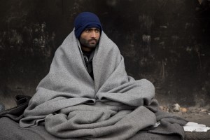 A migrant rests outside an abandoned warehouse where he and other migrants took refuge in Belgrade, Serbia on February 6, 2017. Hundreds of migrants have been sleeping in freezing conditions in central Belgrade looking for ways to cross the heavily guarded EU borders.