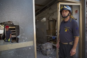 A firefighter works inside the red zone almost one year after the earthquake in the village of Amatrice, central Italy on August 1, 2017. Italy was struck by a powerful 6.2 magnitude earthquake in the night of August 24, 2016 which has killed at least 297 people and devastated dozens of houses in the Lazio village of Amatrice and other Amatrice fractions.