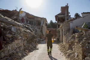 A firefighter walks among the rubble inside the red zone almost one year after the earthquake in the village of Amatrice, central Italy on August 1, 2017. Italy was struck by a powerful 6.2 magnitude earthquake in the night of August 24, 2016 which has killed at least 297 people and devastated dozens of houses in the Lazio village of Amatrice and other Amatrice fractions.