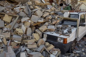 A car crushed by rubble is seen almost one year after the earthquake in the village of Amatrice, central Italy on August 1, 2017. Italy was struck by a powerful 6.2 magnitude earthquake in the night of August 24, 2016 which has killed at least 297 people and devastated dozens of houses in the Lazio village of Amatrice and other Amatrice fractions.