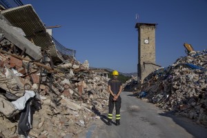 A firefighter walks among the rubble inside the red zone almost one year after the earthquake in the village of Amatrice, central Italy on August 1, 2017. Italy was struck by a powerful 6.2 magnitude earthquake in the night of August 24, 2016 which has killed at least 297 people and devastated dozens of houses in the Lazio village of Amatrice and other Amatrice fractions.
