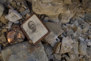 A photo is seen among the rubble of a collapsed building almost one year after the earthquake in the village of Retrosi, central Italy on July 31, 2017. Italy was struck by a powerful 6.2 magnitude earthquake in the night of August 24, 2016 which has killed at least 297 people and devastated dozens of houses in the Lazio village of Amatrice and other Amatrice fractions.