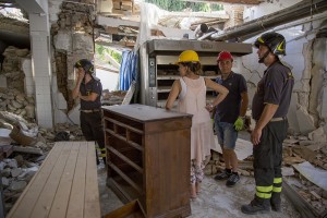 Firefighters help people to find their personal object inside the red zone almost one year after the earthquake in the village of Amatrice, central Italy on August 1, 2017. Italy was struck by a powerful 6.2 magnitude earthquake in the night of August 24, 2016 which has killed at least 297 people and devastated dozens of houses in the Lazio village of Amatrice and other Amatrice fractions.