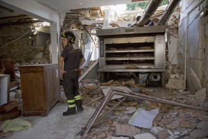 A firefighter works inside the red zone almost one year after the earthquake in the village of Amatrice, central Italy on August 1, 2017. Italy was struck by a powerful 6.2 magnitude earthquake in the night of August 24, 2016 which has killed at least 297 people and devastated dozens of houses in the Lazio village of Amatrice and other Amatrice fractions.