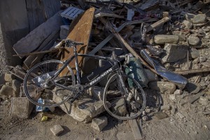 A destroyed bicylce is seen inside the red zone almost one year after the earthquake in the village of Amatrice, central Italy on August 1, 2017. Italy was struck by a powerful 6.2 magnitude earthquake in the night of August 24, 2016 which has killed at least 297 people and devastated dozens of houses in the Lazio village of Amatrice and other Amatrice fractions.