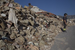 A firefighter works inside the red zone almost one year after the earthquake in the village of Amatrice, central Italy on August 1, 2017. Italy was struck by a powerful 6.2 magnitude earthquake in the night of August 24, 2016 which has killed at least 297 people and devastated dozens of houses in the Lazio village of Amatrice and other Amatrice fractions.