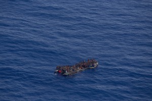 A picture taken from the moonbird aircraft of the German NGO Sea-Watch shows hundreds of migrants inside a rubber dinghy while they try to reach Europe in the Mediterranean Sea on September 15, 2017.