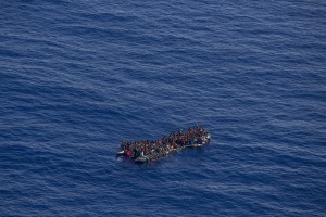 A picture taken from the moonbird aircraft of the German NGO Sea-Watch shows hundreds of migrants inside a rubber dinghy while they try to reach Europe in the Mediterranean Sea on September 15, 2017.