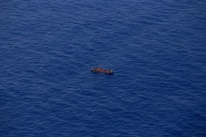 A picture taken from the moonbird aircraft of the German NGO Sea-Watch shows hundreds of migrants inside a rubber dinghy while they try to reach Europe in the Mediterranean Sea on September 15, 2017.