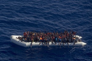 A picture taken from the moonbird aircraft of the German NGO Sea-Watch shows hundreds of migrants inside a rubber dinghy while they try to reach Europe in the Mediterranean Sea on September 15, 2017.