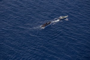 A picture taken from the moonbird aircraft of the German NGO Sea-Watch shows hundreds of migrants inside a rubber dinghy probably intercepted by Libyan militaries while they tried to reach Europe in the Mediterranean Sea on September 15, 2017.