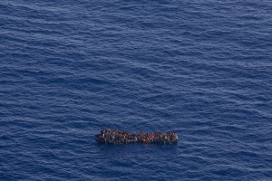 A picture taken from the moonbird aircraft of the German NGO Sea-Watch shows hundreds of migrants inside a rubber dinghy while they try to reach Europe in the Mediterranean Sea on September 15, 2017.