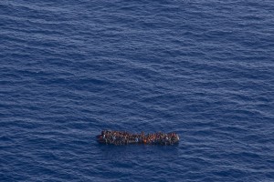 A picture taken from the moonbird aircraft of the German NGO Sea-Watch shows hundreds of migrants inside a rubber dinghy while they try to reach Europe in the Mediterranean Sea on September 15, 2017.