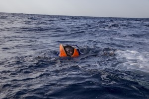 A migrant tries to board a boat of the German NGO Sea-Watch in the Mediterranean Sea on November 6, 2017. During a shipwreck, five people died, including a newborn child. According to the German NGO Sea-Watch, which has saved 58 migrants, the violent behavior of the Libyan coast guard caused the death of five persons.