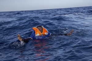 A migrant tries to board a boat of the German NGO Sea-Watch in the Mediterranean Sea on November 6, 2017. During a shipwreck, five people died, including a newborn child. According to the German NGO Sea-Watch, which has saved 58 migrants, the violent behavior of the Libyan coast guard caused the death of five persons.