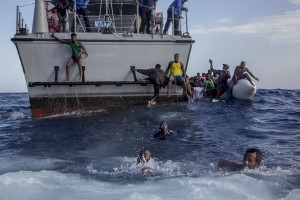 Some migrants swim towards the rescue boats of the German NGO Sea-Watch after having escaped from the Libyan Coast Guard ship in the Mediterranean Sea on November 6, 2017. During a shipwreck, five people died, including a newborn child. According to the German NGO Sea-Watch, which has saved 58 migrants, the violent behavior of the Libyan coast guard caused the death of five persons.