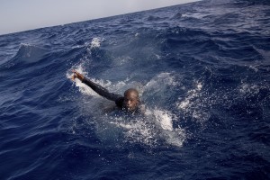 A migrant tries to board a boat of the German NGO Sea-Watch in the Mediterranean Sea on November 6, 2017. During a shipwreck, five people died, including a newborn child. According to the German NGO Sea-Watch, which has saved 58 migrants, the violent behavior of the Libyan coast guard caused the death of five persons.