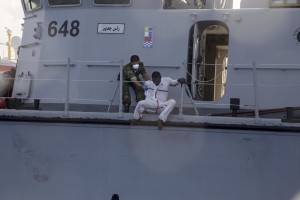 A migrant tries to escape from the Libyan Coast Guard ship after being rescued by them in the Mediterranean Sea on November 6, 2017. During a shipwreck, five people died, including a newborn child. According to the German NGO Sea-Watch, which has saved 58 migrants, the violent behavior of the Libyan coast guard caused the death of five persons.