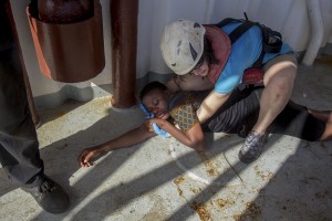 A woman is seen on board of German NGO Sea-Watch ship after her rescue in the Mediterranean Sea on November 6, 2017. During a shipwreck, five people died, including a newborn child. According to the German NGO Sea-Watch, which has saved 58 migrants, the violent behavior of the Libyan coast guard caused the death of five persons.