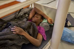 A woman rests inside the ship of German NGO Sea-Watch after her rescue in the Mediterranean Sea on November 6, 2017. During a shipwreck, five people died, including a newborn child. According to the German NGO Sea-Watch, which has saved 58 migrants, the violent behavior of the Libyan coast guard caused the death of five persons.