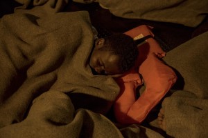 A migrant sleeps on board of German NGO Sea-Watch ship after his rescue in the Mediterranean Sea on November 6, 2017. During the shipwreck November 6,2017 five people died, including a newborn child. According to Sea-Watch, which has saved 58 migrants, the violent behavior of the Libyan coast guard caused the death of five persons. Sea-Watch is a non-governmental organisation founded on May, 19 2015 and is formally registered as a non-profit organisation in Berlin.