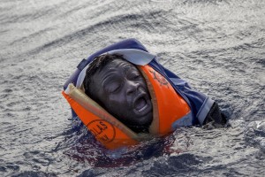 A migrant tries to board a boat of the German NGO Sea-Watch in the Mediterranean Sea on November 6, 2017. During a shipwreck, five people died, including a newborn child. According to the German NGO Sea-Watch, which has saved 58 migrants, the violent behavior of the Libyan coast guard caused the death of five persons.