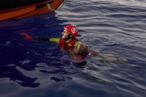 A member of the Spanish NGO Proactiva Open Arms carries a dead child about 85 miles off the Libyan coast in the Mediterranean sea on July 17, 2018.