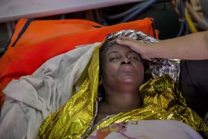 A doctor of the Spanish NGO Proactiva Open Arms takes care of Josepha, an African migrant from Cameroon, rescued about 85 miles off the Libyan coast in the Mediterranean sea on July 17, 2018.