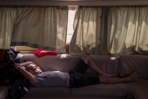 A member of the Spanish NGO Proactiva Open Arms rests on a sofa inside “Astral” ship after the rescue of Josepha, an African migrant from Cameroon, about 85 miles off the Libyan coast in the Mediterranean sea on July 17, 2018.