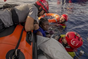 Members of the Spanish NGO Proactiva Open Arms rescue Josepha, an African migrant from Cameroon, about 85 miles off the Libyan coast in the Mediterranean sea on July 17, 2018.