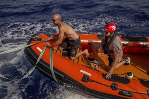 A member of the Spanish NGO Proactiva Open Arms and NBA Memphis player Marc Gasol at work after the rescue of Josepha, an African migrant from Cameroon, about 85 miles off the Libyan coast in the Mediterranean sea on July 17, 2018.