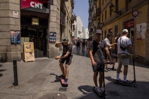 People walk in the streets of Raval district in Barcelona, Spain on July 12, 2018. The Raval is one of the most multicultural and colorful neighborhoods in the city and it hosts numerous artists and galleries.