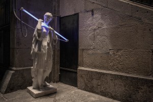 A statue holding a neon is seen in a street of Barcelona, in Spain on July 5, 2018.