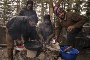 Migrant prepare food outside an abandoned building in the outskirts of the Bosnian city of Bihać, Bosnia and Herzegovina on November 28, 2018.