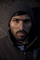 Bashir, 20 years old from Gujranwala, Pakistan is portrayed outiside a reception center in Velika Kladusa, Bosnia and Herzegovina on November 30, 2018.