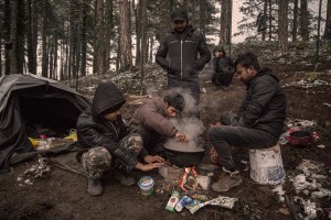 Migrant prepare food outside an abandoned building in the outskirts of the Bosnian city of Bihać, Bosnia and Herzegovina on November 28, 2018.