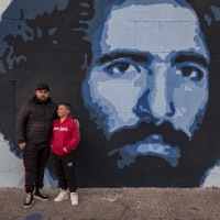 Gaetano (sx) and Giulio (dx) are portrayed near a mural depicting Claudio Miccoli, who was an Italian environmentalist died in 1978 afters the attack by neo-fascist thugs, in Scampia district, Naples, Italy on March 9, 2019. The mural is located near the ”garden of non-violence and the five continents” and is part of a project realized by “Raro” and Fabio della Ratta “biodpi”,  with the collaboration of three boys from Gambia.