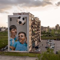 The mural entitled “Chi è vulut bene, nun so scorda” (whoever is loved, doesn’t forget it) realized by the Italian street artists “Rosk&Loste” on the facade of a palace inside the so called “Park of murals” in Ponticelli, near Naples, Italy on April 8, 2019. An artistic redevelopment and social regeneration program promoted by INWARD (observatory on urban creativity) has been starting since 2015.