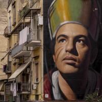 A mural depicting Saint Januarius realized by the Italian street artist “Jorit” is seen on the facade of a palace in the historical center of Naples, in Italy on March 19, 2019. Januarius was a bishop and a Christian martyr. He is venerated as a saint by the Catholic Church and the Orthodox Church and is considered the saint patron of Naples.