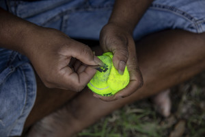 A player prepares a ball removing the fur before a match of “elle” in Naples, Italy on September 29, 2019. Every Sunday hundreds of people belonging to the Sri Lankan community in Italy gather in the “Real Bosco di Capodimonte” of Naples and play “elle”, a very popular Sri Lankan bat-and-ball game, often played in rural villages and urban areas.