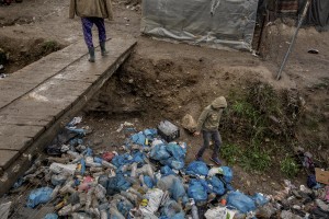 A boy collects plastic bottles inside the Moria refugee camp on the island of Lesbos in Greece on February 20, 2020. Many people, when they can’t find wood to light the fire burn the plastic, often causing them breathing problems. About 20000 migrants and asylum seekers – mostly coming from Afghanistan and Syria – live in the official Moria camp and in the olive grove that is located nearby.