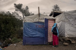 A Somali woman is seen outside the tent where she lives in the Moria refugee camp on the island of Lesbos in Greece on February 20, 2020. About 20000 migrants and asylum seekers – mostly coming from Afghanistan and Syria – live in the official Moria camp and in the olive grove that is located nearby.