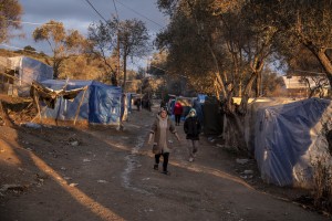 People walk inside the Moria refugee camp on the island of Lesbos in Greece on February 21, 2020. About 20000 migrants and asylum seekers – mostly coming from Afghanistan and Syria – live in the official Moria camp and in the olive grove that is located nearby.