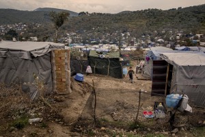 A child walks inside the Moria refugee camp on the island of Lesbos in Greece on February 20, 2020. About 20000 migrants and asylum seekers – mostly coming from Afghanistan and Syria – live in the official Moria camp and in the olive grove that is located nearby.