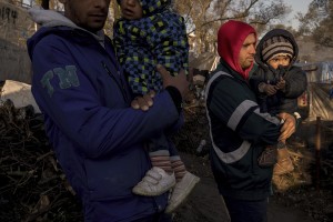 Two Afghan men with their children are seen inside the Moria refugee camp on the island of Lesbos in Greece on February 18, 2020. About 20000 migrants and asylum seekers – mostly coming from Afghanistan and Syria – live in the official Moria camp and in the olive grove that is located nearby.