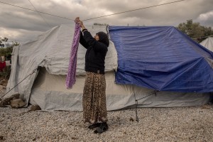 A woman puts clothes to dry inside the Moria refugee camp on the island of Lesbos in Greece on February 21, 2020. About 20000 migrants and asylum seekers – mostly coming from Afghanistan and Syria – live in the official Moria camp and in the olive grove that is located nearby.